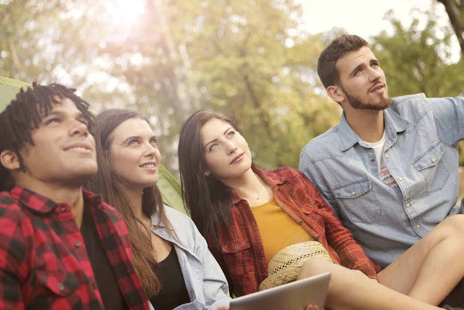 Group of diverse people of different ages laughing together outdoors.
